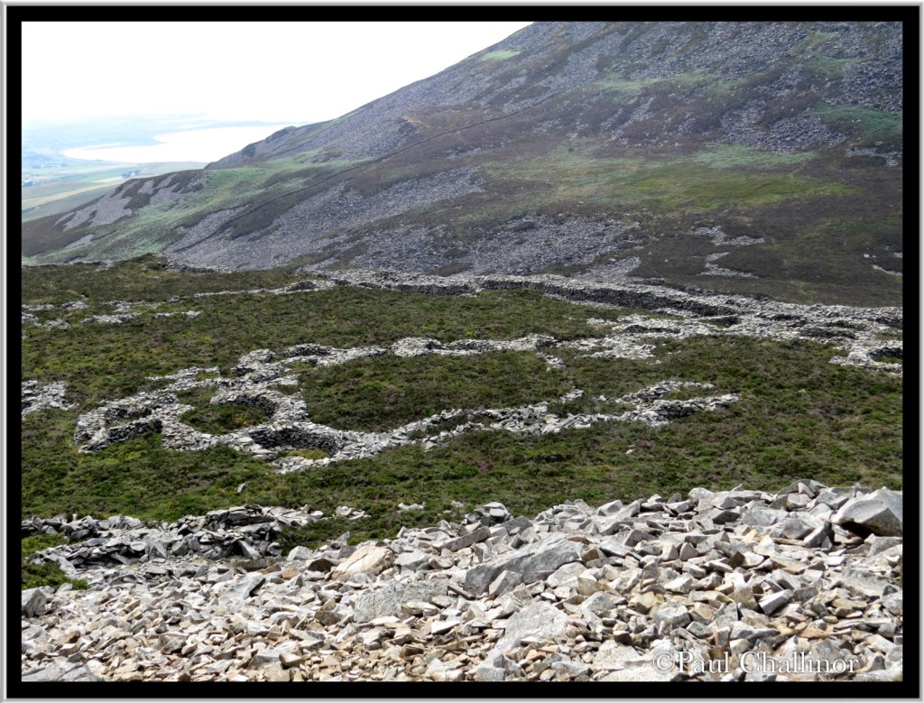The remains of some of the circular huts are clearly visible, showing their relationship with each other.