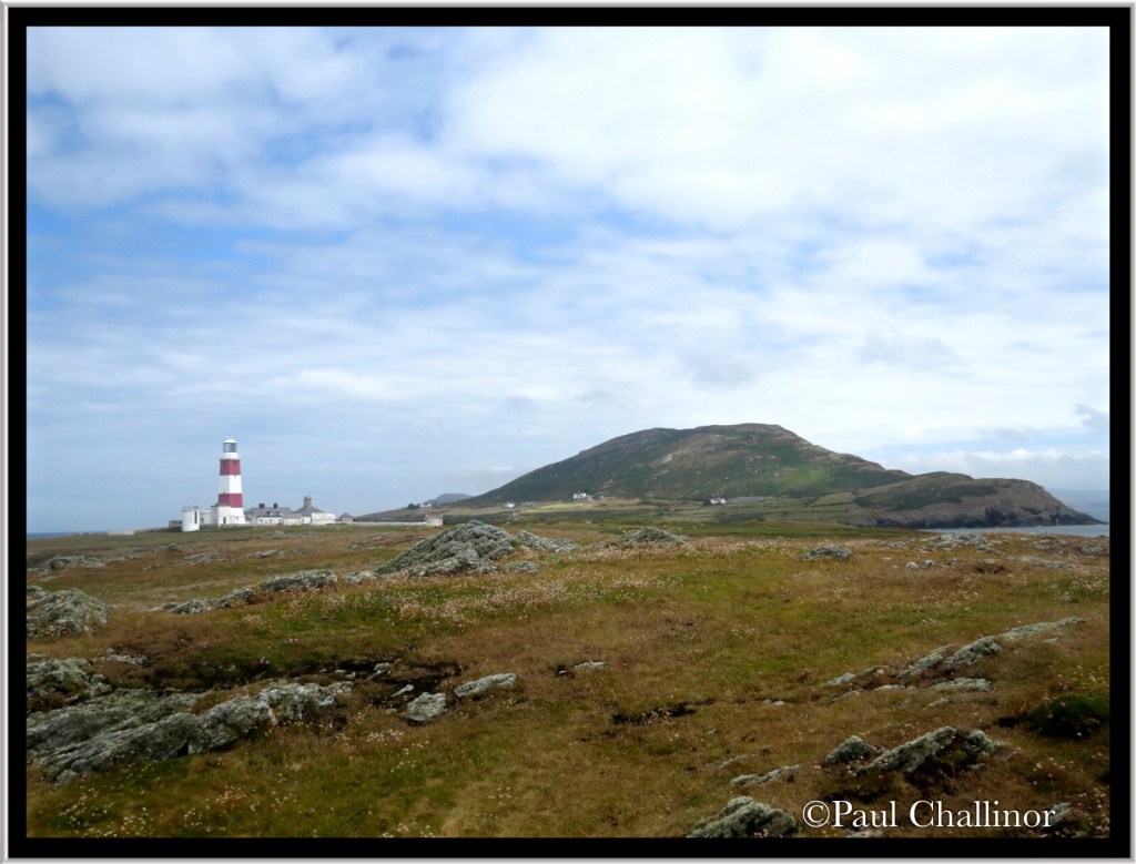 The light house with Mynydd Enlli in the background.