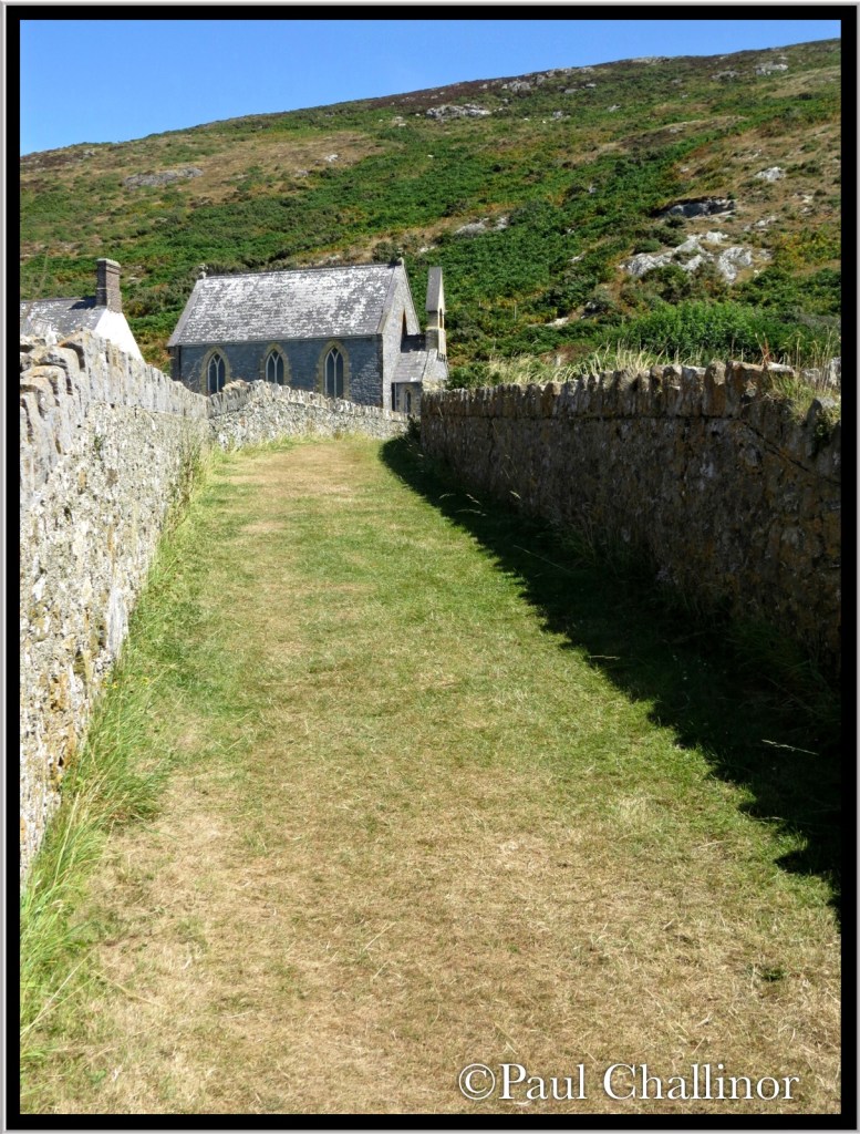 The path to the chapel. There is no resident preacher any more, but the sign outside the gate suggests that preacher visit for a week or more to provide services to those who travel to the island.