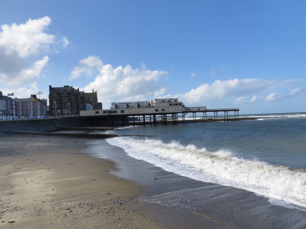 Looking south towards pier. The original University can be seen behind. This gothic style building was originally built as a hotel when the railway arrived in Aberystwyth.
