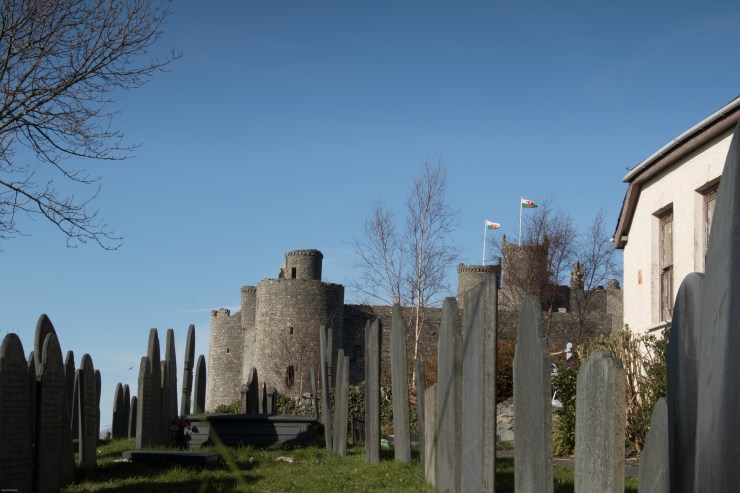 A small chapel graveyard perched on the cliff side, under the castle walls.