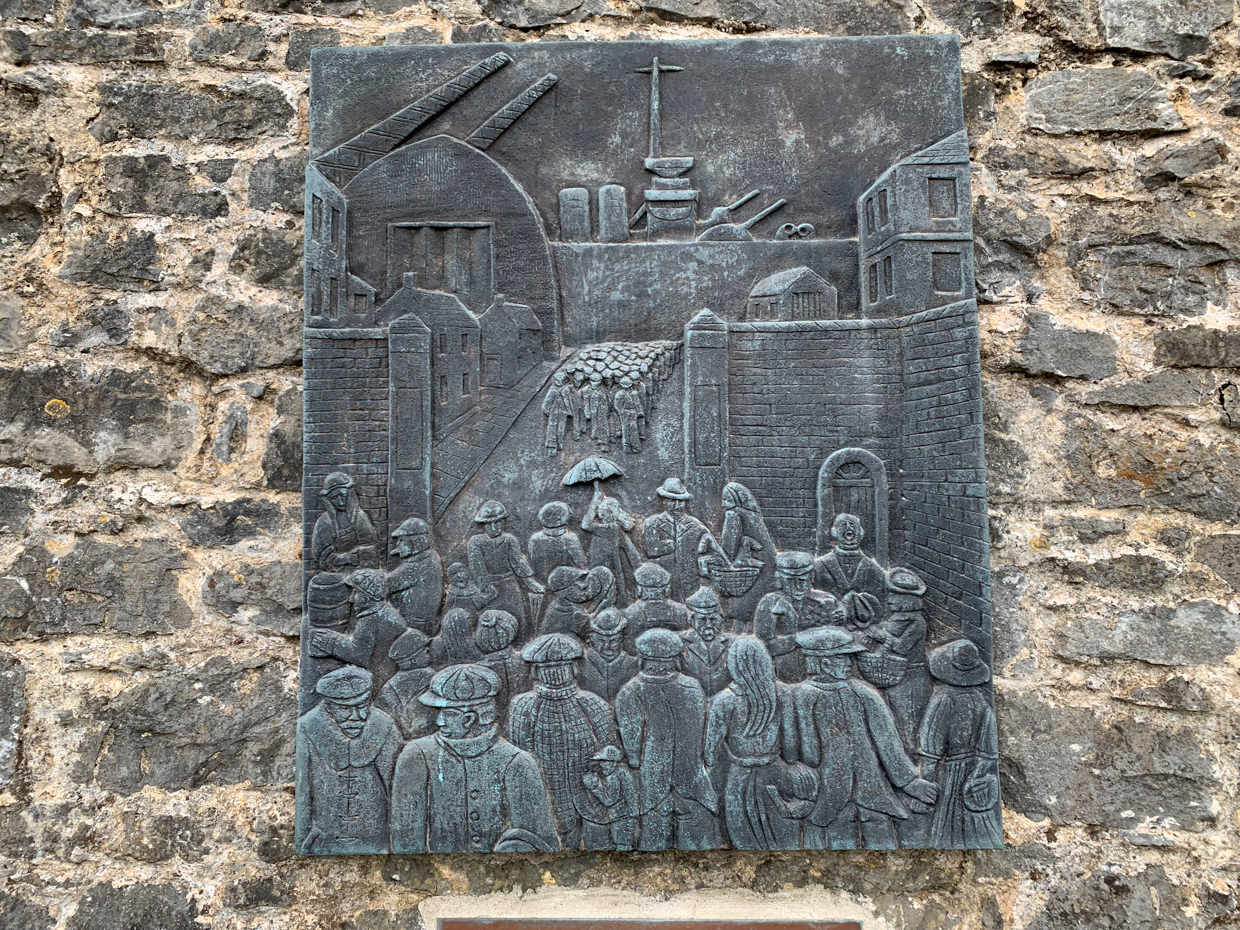 A fantastic relief plaque showing shift change at the dockyards.